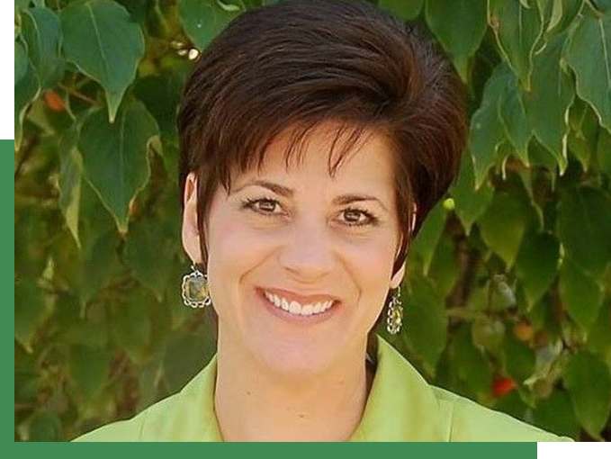 A woman with short hair is smiling for the camera.