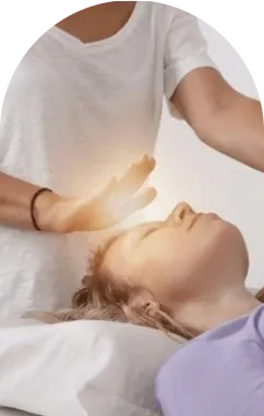 A person is doing reiki on another person 's face.